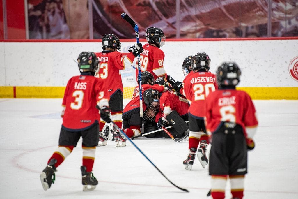 Youth hockey players competing on the ice